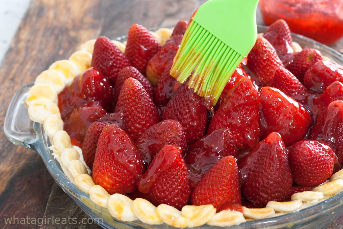 Brushing the glaze on the strawberry pie.