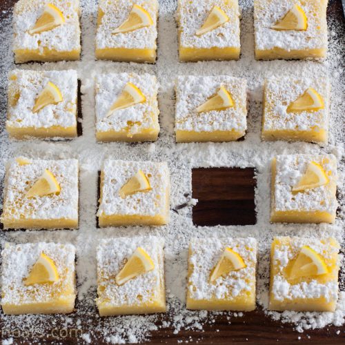 lemon bars on cutting board.
