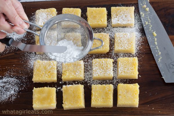 lemon bars on cutting board.