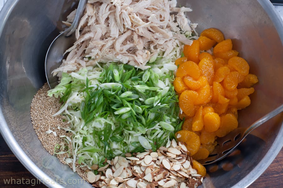 Healthy Chinese chicken salad ingredients in a bowl before mixing.