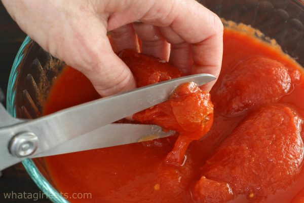 cutting tomatoes with scissors.