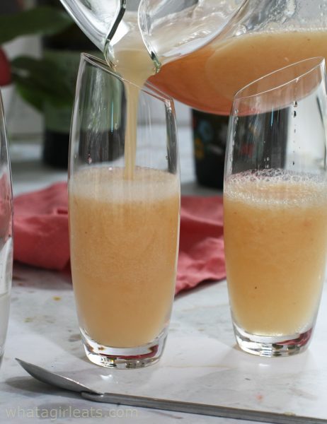 filling a glass with bellini.