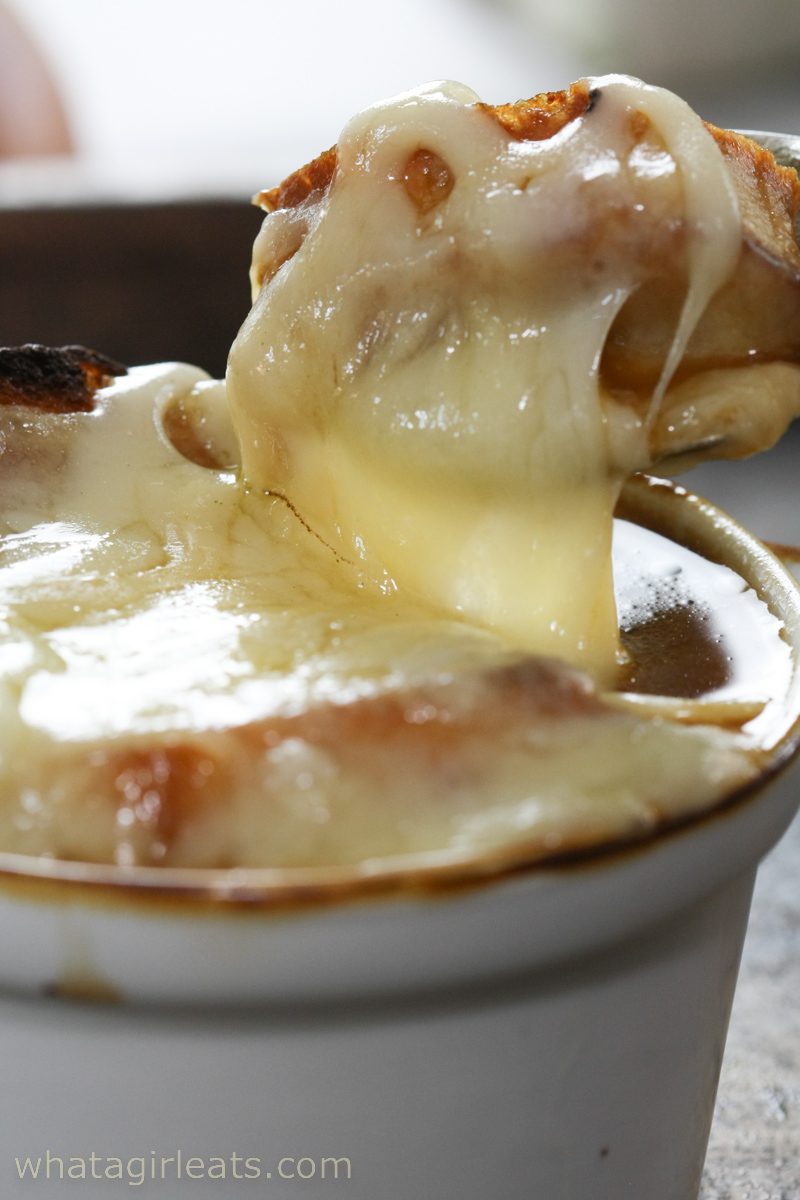 Closeup of French onion soup with cheese.