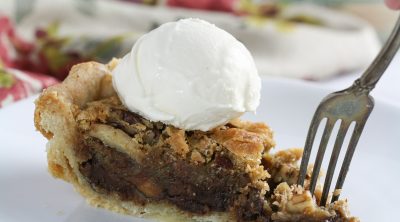 Chocolate pecan pie on a fork.