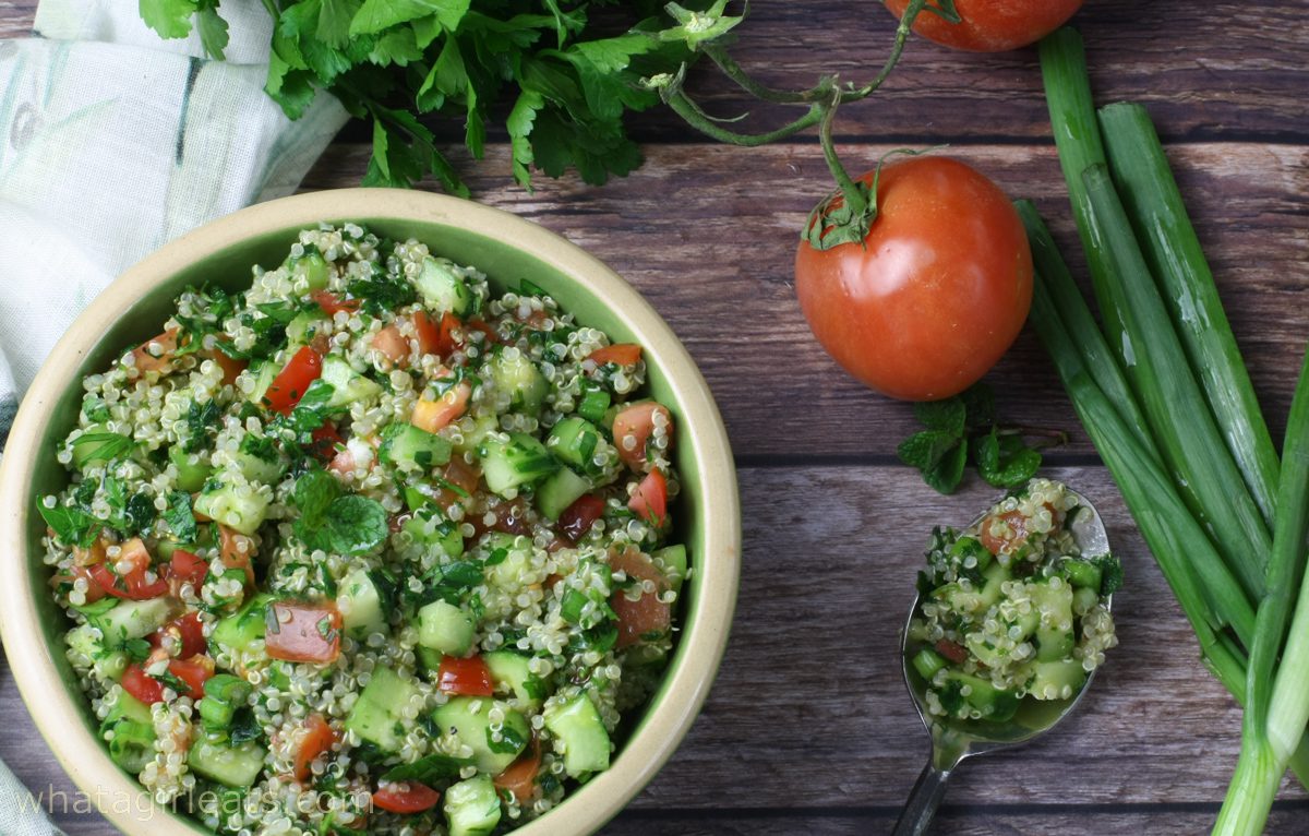 Quinoa tabbouleh on brown picnic bench.