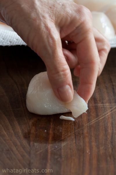 removing the foot of the scallop.