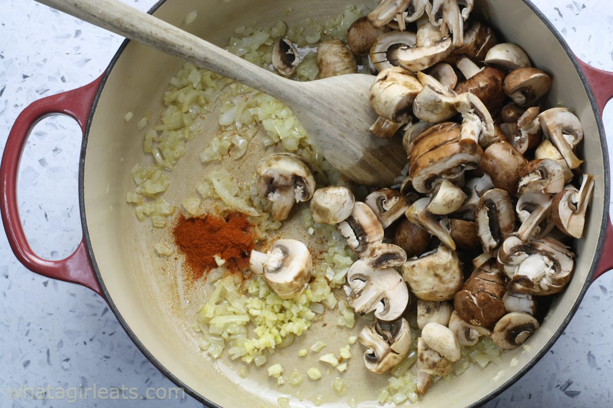 Adding mushrooms, garlic and paprika.