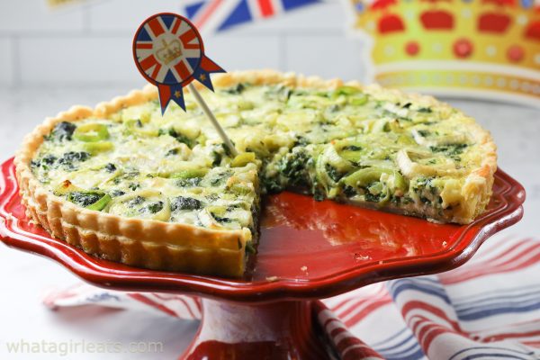 Coronation quiche with flag on red plate.