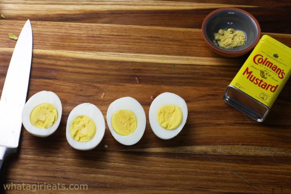 hard boiled eggs on cutting board.