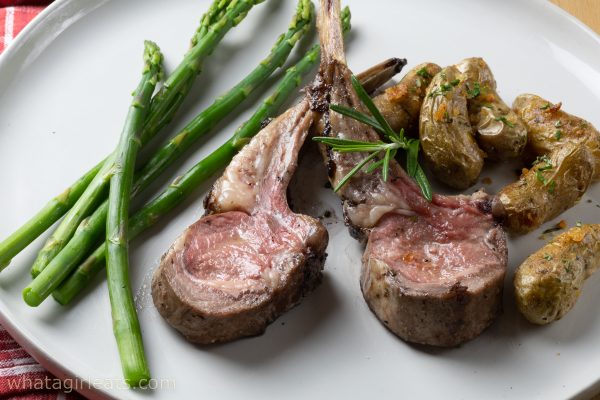 Lamb on plate with asparagus.