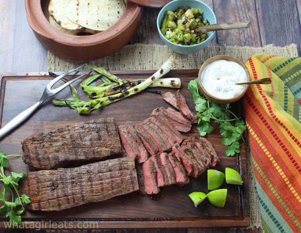 Sliced flank steak with jalapenos and lime.