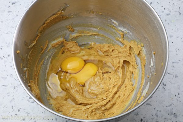 adding eggs to ginger cake batter.