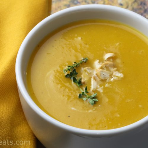 Roasted butternut squash soup in white bowl.