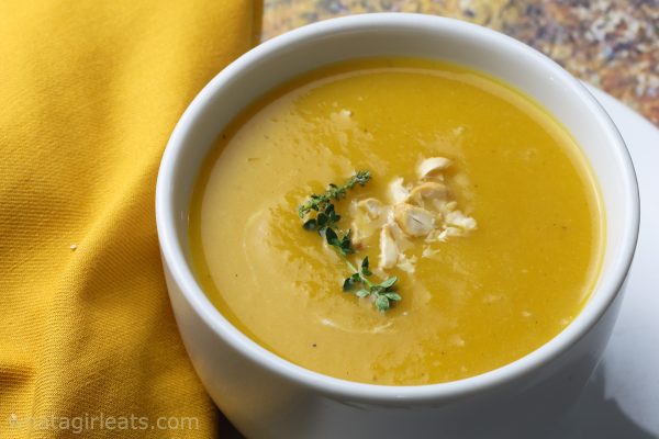 Roasted butternut squash soup in white bowl.