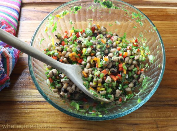 mixing all the ingredients for texas caviar.
