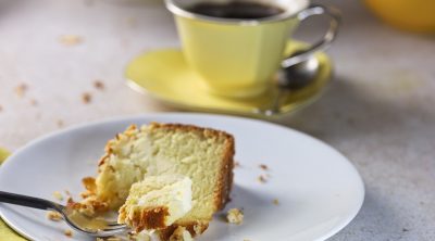 cake on fork with yellow cup.