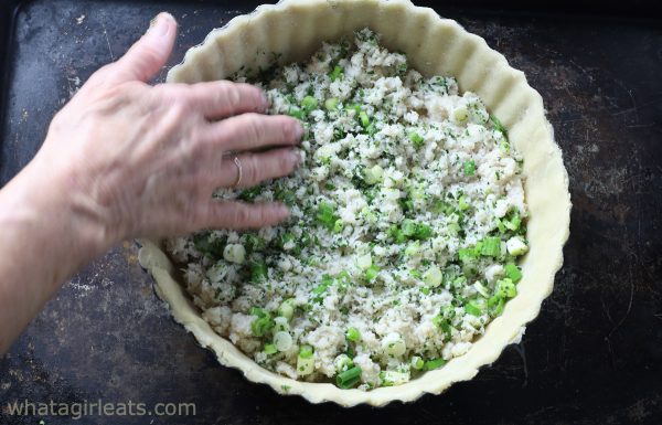 adding crab mixture to bottom of quiche pan.