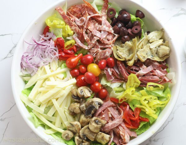 Antipasto salad in a white bowl.
