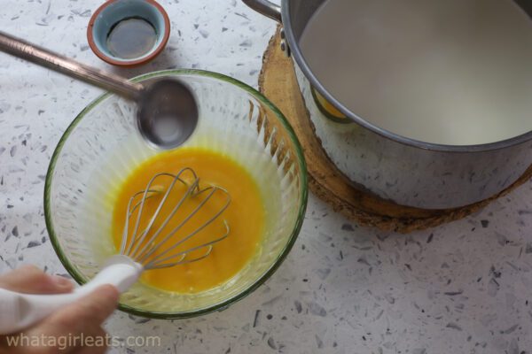 adding cream to yolks.