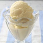 Vanilla bean ice cream in glass dish.