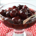 Amaretto cherries in glass dish.