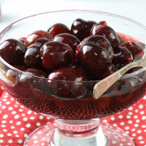 Amaretto cherries in glass dish.