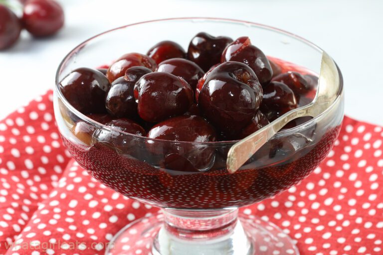 Amaretto cherries in glass dish.