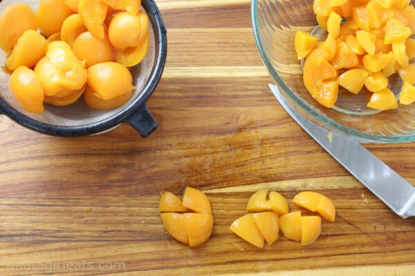 cutting apricots on board.