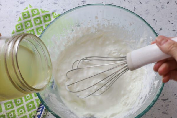 whisking lime juice into cream.