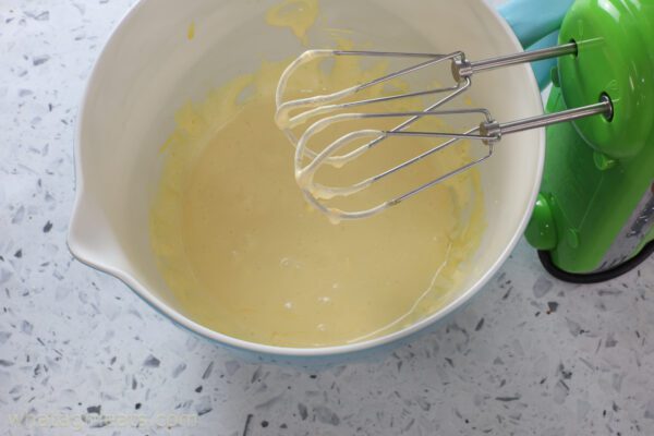 whipping eggs and sugar.
