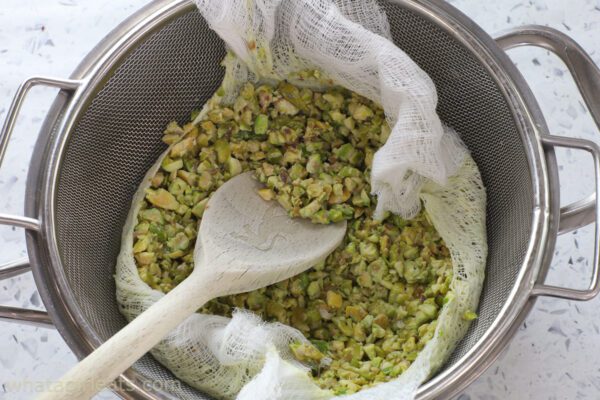 pressing out pistachio infused milk.