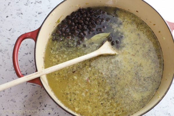 adding black beans to broth.