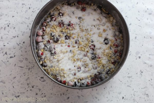 adding sugar to cranberries and walnuts.