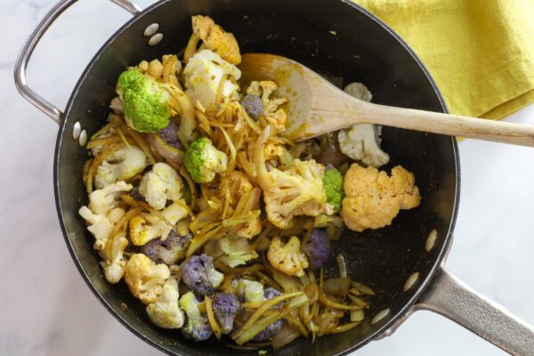 stir frying cauliflower in wok.