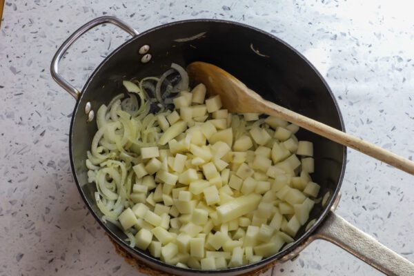 potatoes and onions in fry pan.