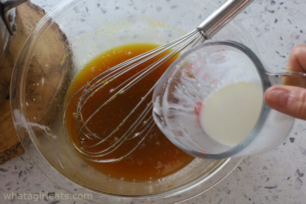 adding cream to maple syrup.
