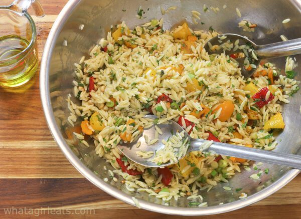 tossing orzo salad.