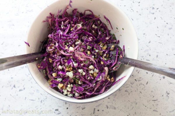 tossing cabbage in large bowl.