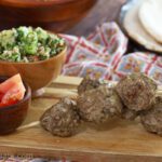 lamb meatballs on wooden board.