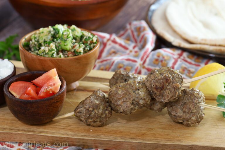 lamb meatballs on wooden board.
