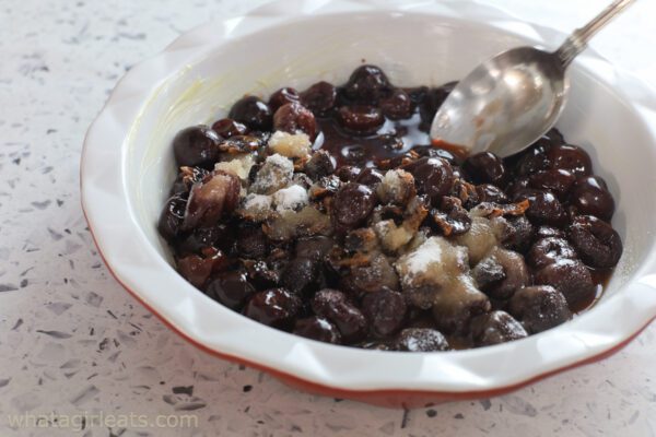 mixing sugar with cherries.