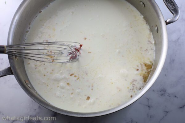 adding cream and tomato paste.