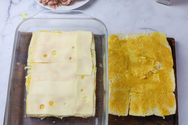 cheese and mustard on hawaiian rolls.
