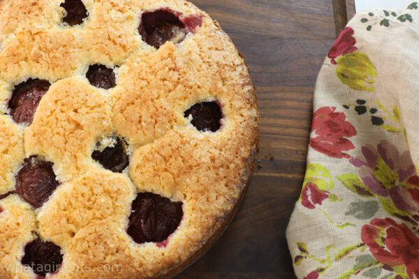 Plum cake on wooden board.