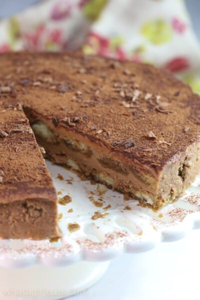 slice out of choclate tiramisu Round tiramisu with slice cut out.