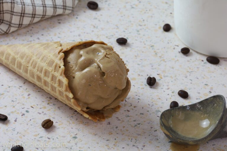 coffee gelato in waffle cone with scoop.