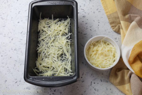 cheese in bottom of loaf pan.