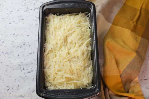 shredded cheese on top of loaf.