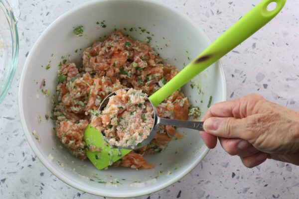 salmon mixture in measuring spoon.