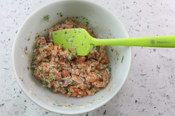 mixing salmon with bread crumb mixture.